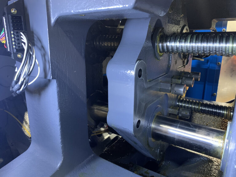 Shows the location of FasTie couplers on the butterfly plate of an injection molding machine